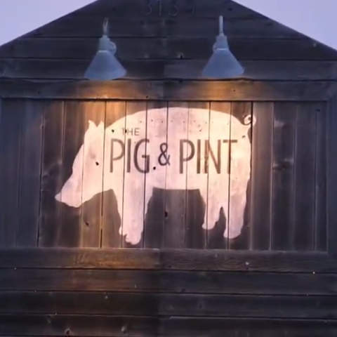 pig and ping video still of barn and pig and pint logo painted on the side